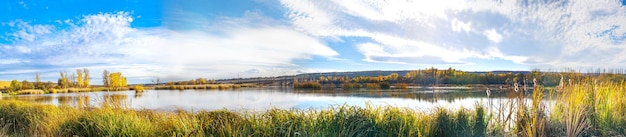 Photo panorama of an autumn landscape on a lake with yellowed trees