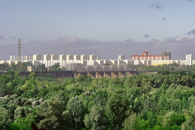 Photo panorama of the big city new multistorey high buildings on the horizon railway bridge