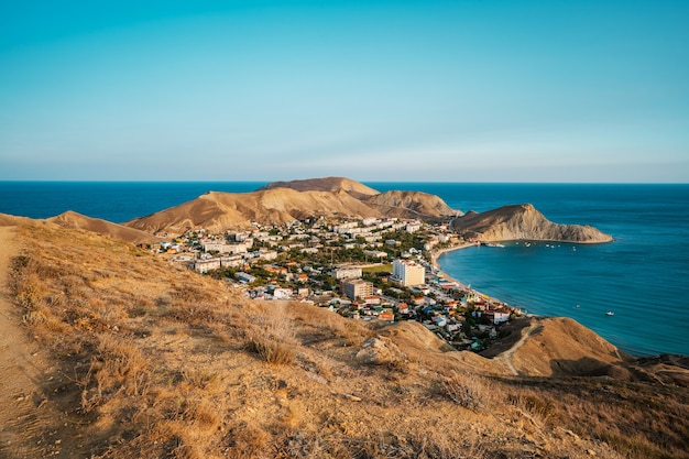 Panorama black sea coast landscape of village in Crimea photographed at sunset from a high mountain