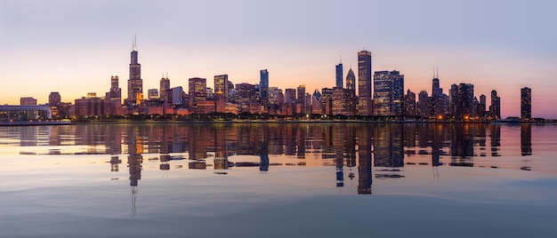 Panorama of cityscape skyline of chicago from the old observatory at sunset and reflected in artificial water surface