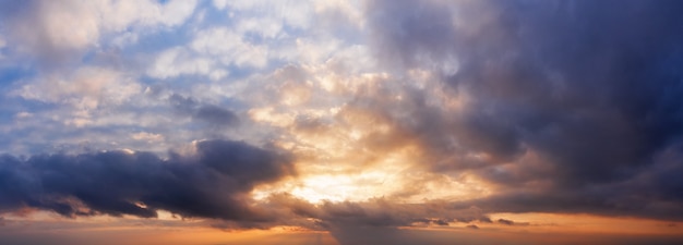 Panorama of dramatic cloudy sky at sunset