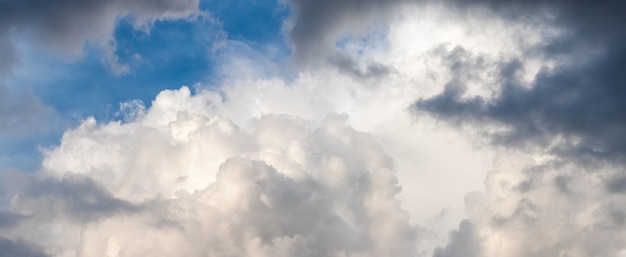 Panorama of dramatic sky with light and dark storm clouds