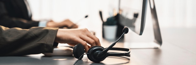 Photo panorama focus headset on call center workspace desk with blur operator prodigy