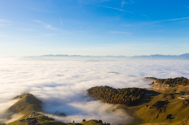 Panorama from Italian alps, carpet of clouds and peaks. Top mountain landscape
