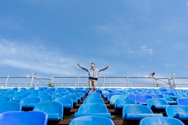 Panorama of huge stadium seats with a man watching the music event concerts