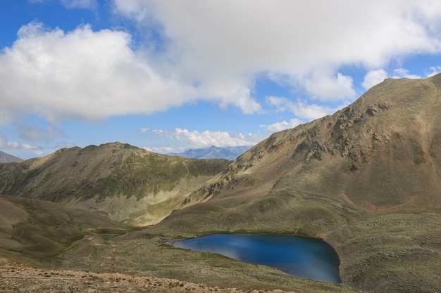 Panorama of lake scenes in mountains, national park Dombay, Caucasus, Russia, Europe. Dramatic blue sky and sunny landscape in summer day