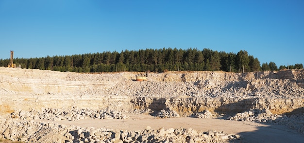 Panorama of limestone quarry on sunny day