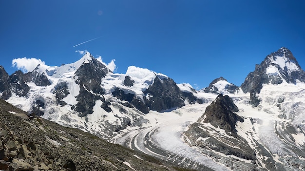 Panorama of a mountain ridge with Ober Gabelhorn and Dent Blanche peaks of Swiss Alps