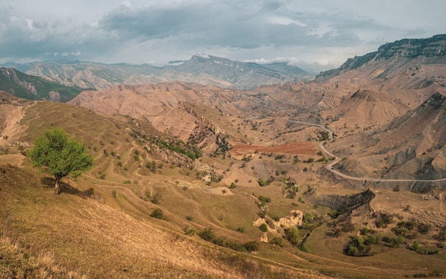 panorama of a mountain valley with a serpentine road. 