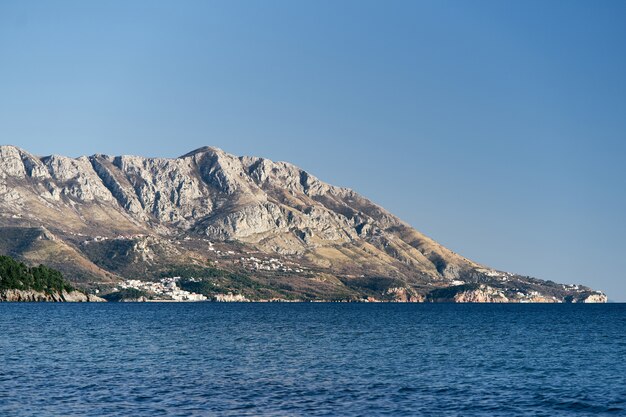 Panorama of mountains with green trees by the sea