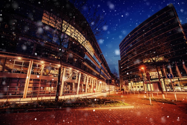 Panorama of the night city of Dusseldorf in winter during a snowstorm Bokeh light effect soft filter