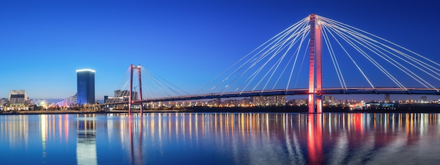 Panorama night city of Krasnoyarsk bridge in lights