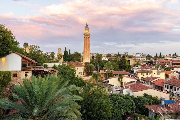 Panorama of the old city in Antalya the old port in the harbor are yachts and ships evening illumination of the city