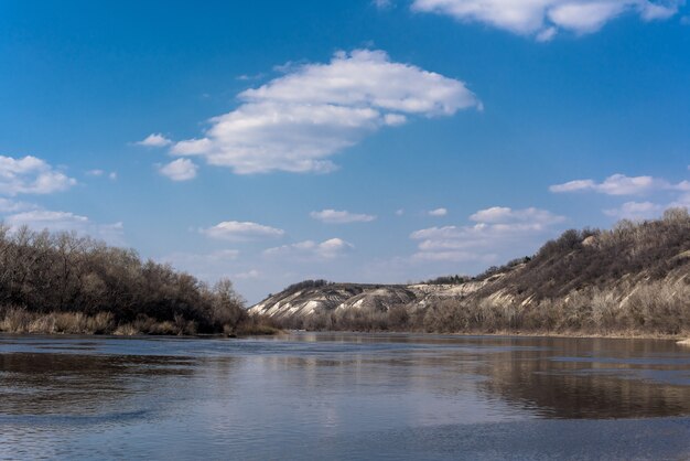 Panorama of the river. wide channel, blue sky. mountain shore