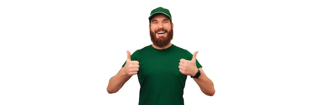 Panorama shot of a bearded delivery man showing thumb up at the camera
