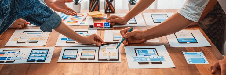 Photo 前端开发团队在纸上为移动应用程序进行 ui 和 ux 设计的全景拍摄 用户界面开发团队为用户友好的 ui 设计进行规划