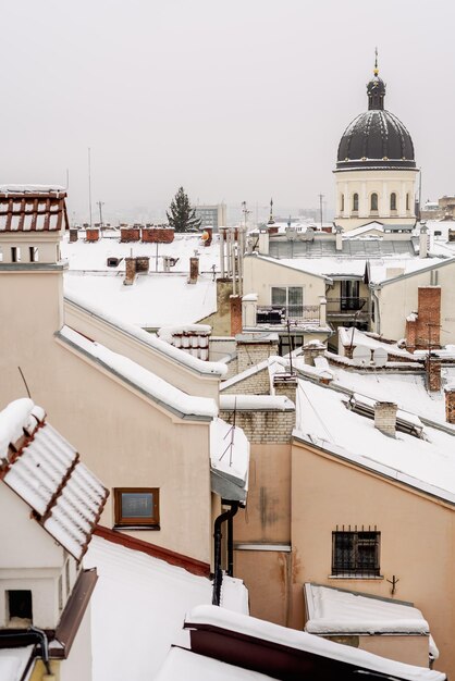 Panorama of snowy roofs of buildings Lviv Ukraine December 2023