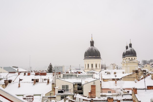 Panorama of snowy roofs of buildings Lviv Ukraine December 2023