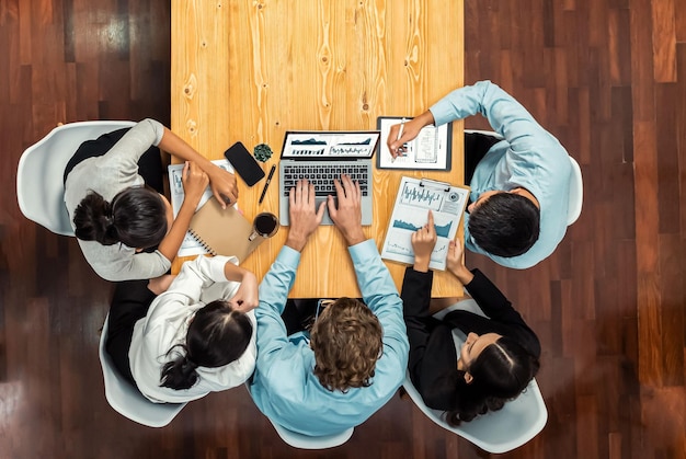 Photo panorama top view diverse group of business analyst team analyzing financial data report paper on meeting table chart and graph dashboard by business intelligence analysis meticulous