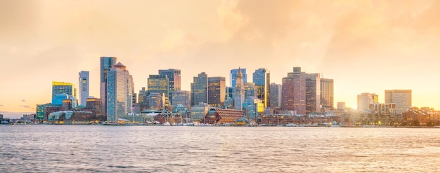 Panorama view of Boston skyline with skyscrapers over water at twilight in United States