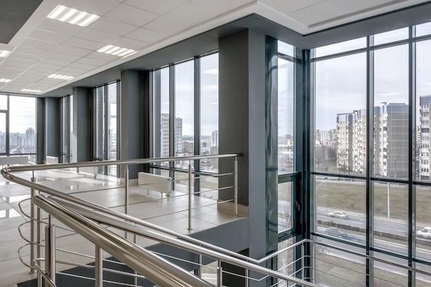 Photo panorama view in empty modern hall with columns doors stairs and panoramic windows