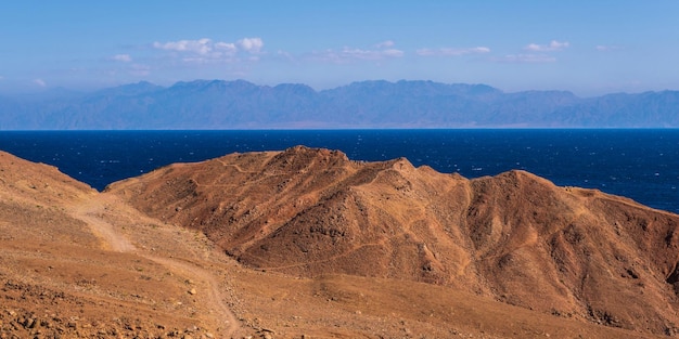 Panorama view from the height of the mountains range to the blue sea