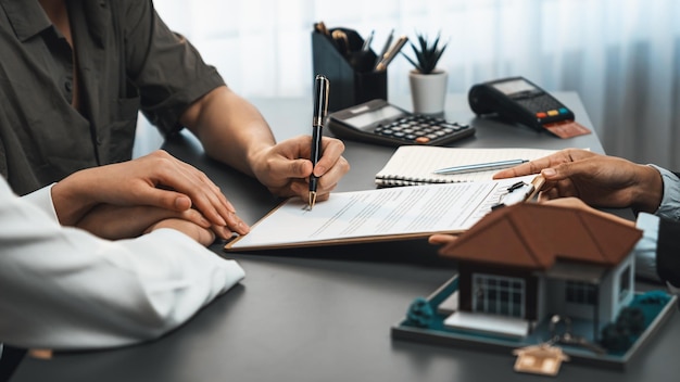 Panorama view of married couple signing house loan contract with broker Prodigy