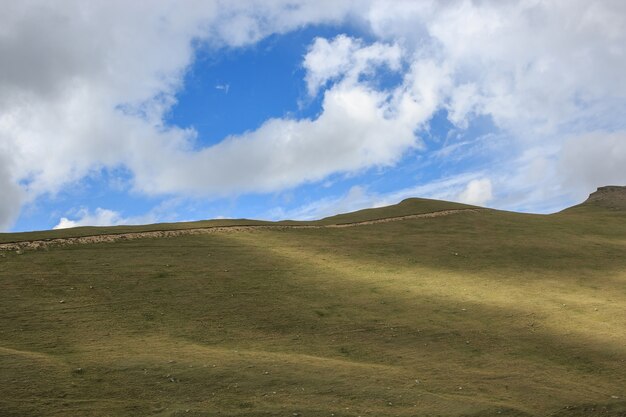 Panorama view of mountains scenes in national park Dombay, Caucasus, Russia, Europe. Dramatic blue sky and sunny summer landscape