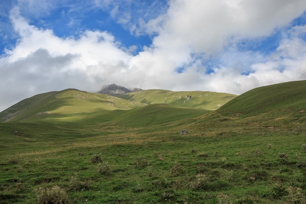 Panorama view of mountains scenes in national park Dombay, Caucasus, Russia, Europe. Dramatic blue sky and sunny summer landscape