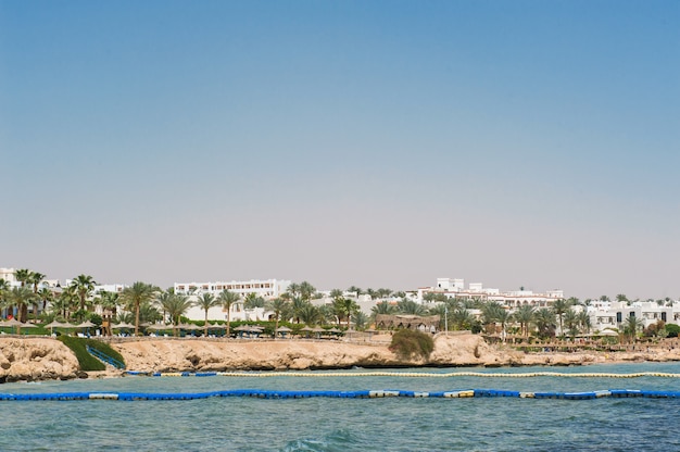 Panorama of white city and the blue sea with a coast line.