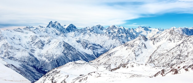 Panorama of winter mountains in snow. Landscape with high peaks