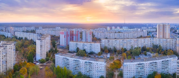 Panorama of the wonderful orange dawn with mauve sky on the cityscape with panel houses