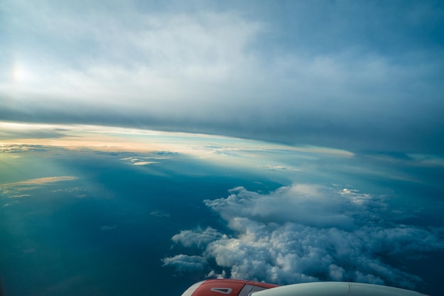 Panoramic aerial view Beautiful sunset sky above clouds with dramatic light Cabin view from airplane Passenger airliner Business trip Commercial aircraft