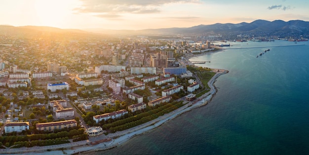 Panoramic aerial view of Novorossiysk seafront and port at sunset