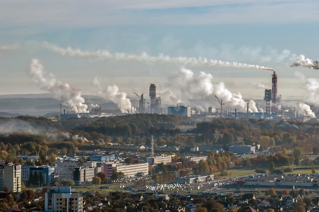 Panoramic aerial view of the smoke of pipes as background of huge residential complex with highrise buildings and private sector Air and water pollution concept