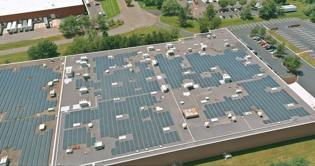 Panoramic aerial view on solar panels on factory roof absorb sunlight as a source of energy to gener