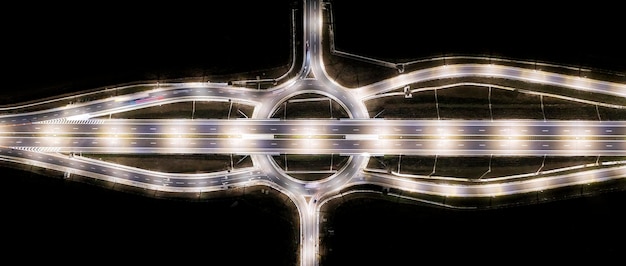Panoramic aerial view of urban highway intersection road in the night light