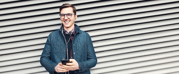 Panoramic banner, portrait of young laughing man wearing eyeglasses