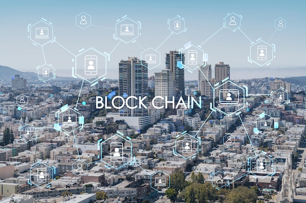 Panoramic cityscape view of San Francisco financial downtown at day time from rooftop California United States Decentralized economy Blockchain cryptography and cryptocurrency concept hologram