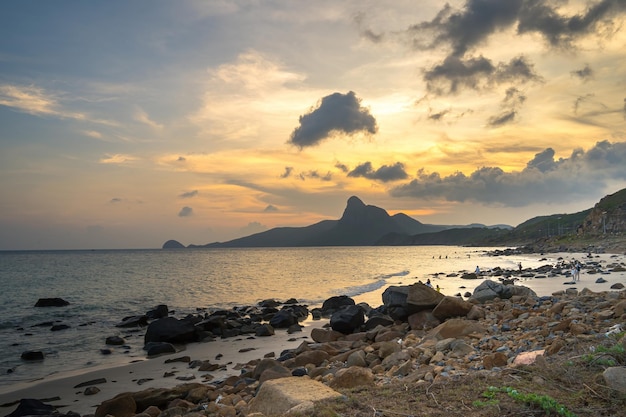 Panoramic coastal Con Dao island view from above with waves coastline clear sky and road blue sea and mountain Aerial view of Bai Nhat beach with cinematic sunset