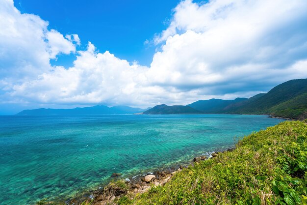 Panoramic coastal con dao island view from above with waves coastline clear sky and road blue sea and mountain