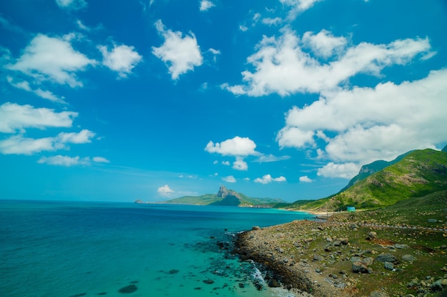 Panoramic coastal Con Dao view from above with waves coastline clear sky and road blue sea and m