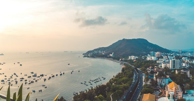 Panoramic coastal Vung Tau view from above with waves coastline streets coconut trees mountain