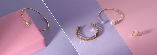 Panoramic photo collage of golden jewelry on pink and purple background