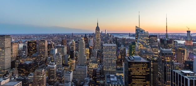 Panoramic photo of New York City Skyline Manhattan downtown Empire State Building skyscrapers at night USA