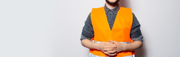 Panoramic portrait of construction worker in vest on white with copy space