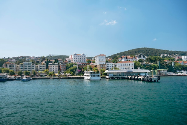 Panoramic sea view of the resort town with houses in the mountains and a pier with boats on a Adalar