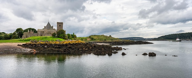 Panoramic seascape with a small island that houses a ruined medieval abbey Edinburgh Scotland