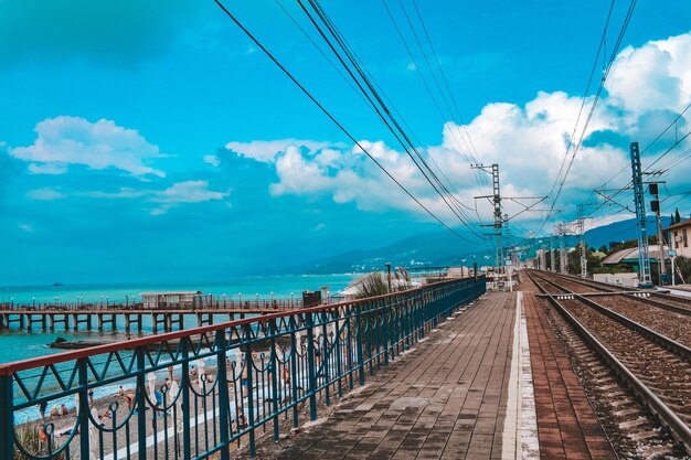 Panoramic shot of electricity pylon against blue sky