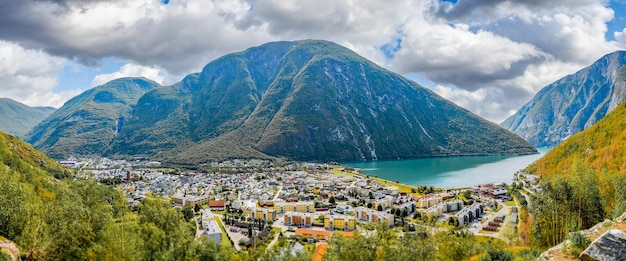 A panoramic shot of houses and fjord surrounded by mountains in andalsnes, norway